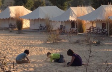 kids playing in the desert sand